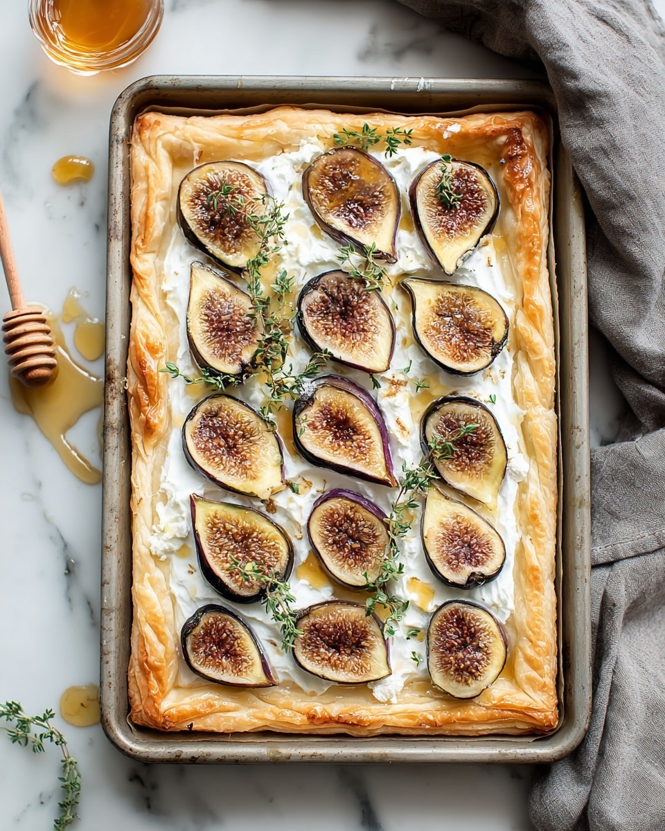 A rectangular tart on a metal baking tray with golden, flaky crust edges slightly curled. The tart has a white creamy layer as the base, spread evenly. On top, there are twelve half figs with a golden brown inside and dark purple skin facing down, scattered evenly across the tart. Fresh green thyme sprigs are placed lightly over the figs. Around the tart, there are small drops of honey, and a honey dipper is visible on the white marbled surface next to the tray. A grey cloth is draped in the upper right corner. Photo taken with an iphone --ar 4:5 --v 7