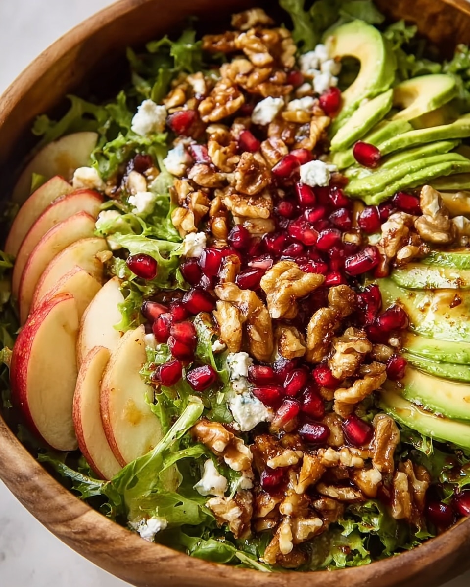 A fresh salad is shown in a white bowl sitting on a white marbled surface. The salad has several layers, starting with a base of mixed green leafy lettuce with varying shades of green and ruffled edges. On top of the greens are slices of green pear that are thin and crescent-shaped, along with clusters of red pomegranate seeds scattered evenly across the bowl. There are also light blue chunks of blue cheese spread throughout. Golden-brown walnuts add a rough texture and are placed throughout the salad. A glossy dressing lightly coats parts of the salad, making some areas look shiny. A metal fork rests inside the bowl, partially buried in the salad, ready to be used. photo taken with an iphone --ar 4:5 --v 7
