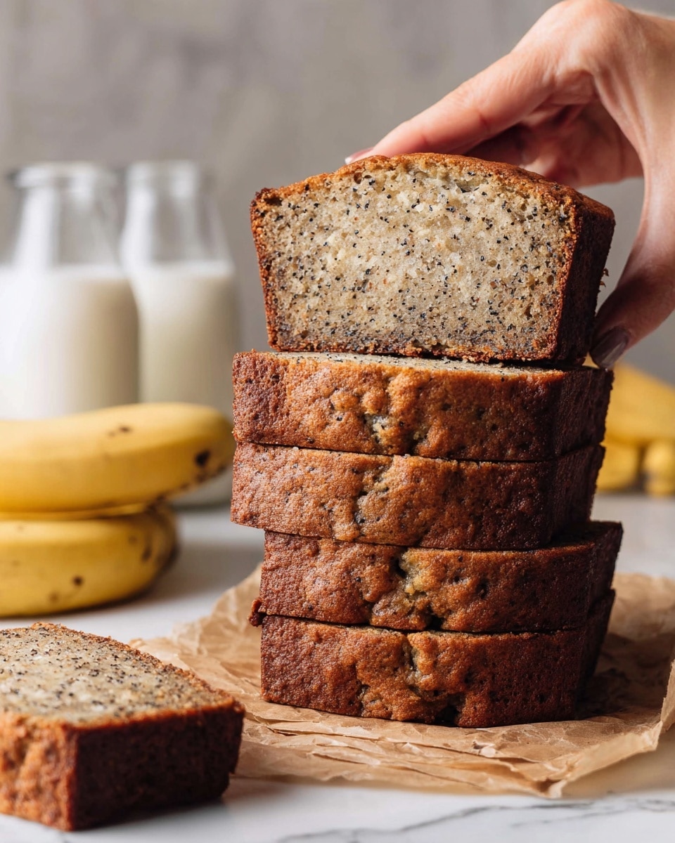 A stack of five thick banana bread slices with a golden-brown crust and a moist, speckled light brown inside sits on a piece of parchment paper on a white marbled surface. Four slices are stacked evenly, while a woman's hand lifts the top slice, showing its soft texture. In the background, two full yellow bananas and two glass bottles filled with milk are softly blurred, adding a fresh and natural feel to the scene. Photo taken with an iphone --ar 4:5 --v 7