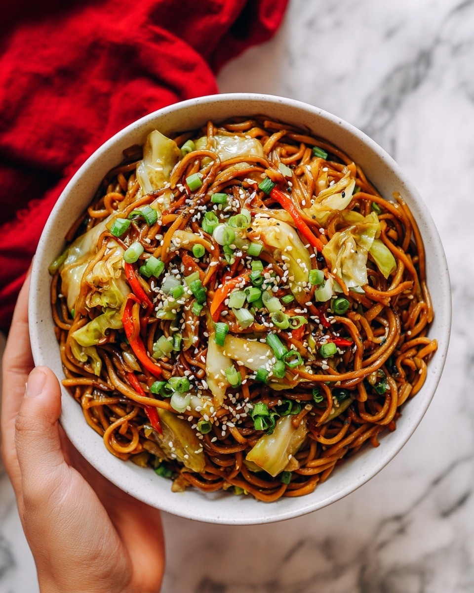 A close-up of a white bowl filled with a cooked dish that has about three main layers visible. The bottom layer is shredded, browned cabbage with a soft texture and light brown color. Above this is a layer of thin, red strips that look like pickled ginger, offering a slight pop of bright red. The top layer is sprinkled with fresh green sliced scallions and white sesame seeds, adding a fresh and crunchy texture. The bowl sits on a white marbled surface with a red cloth blurred in the background. photo taken with an iphone --ar 4:5 --v 7