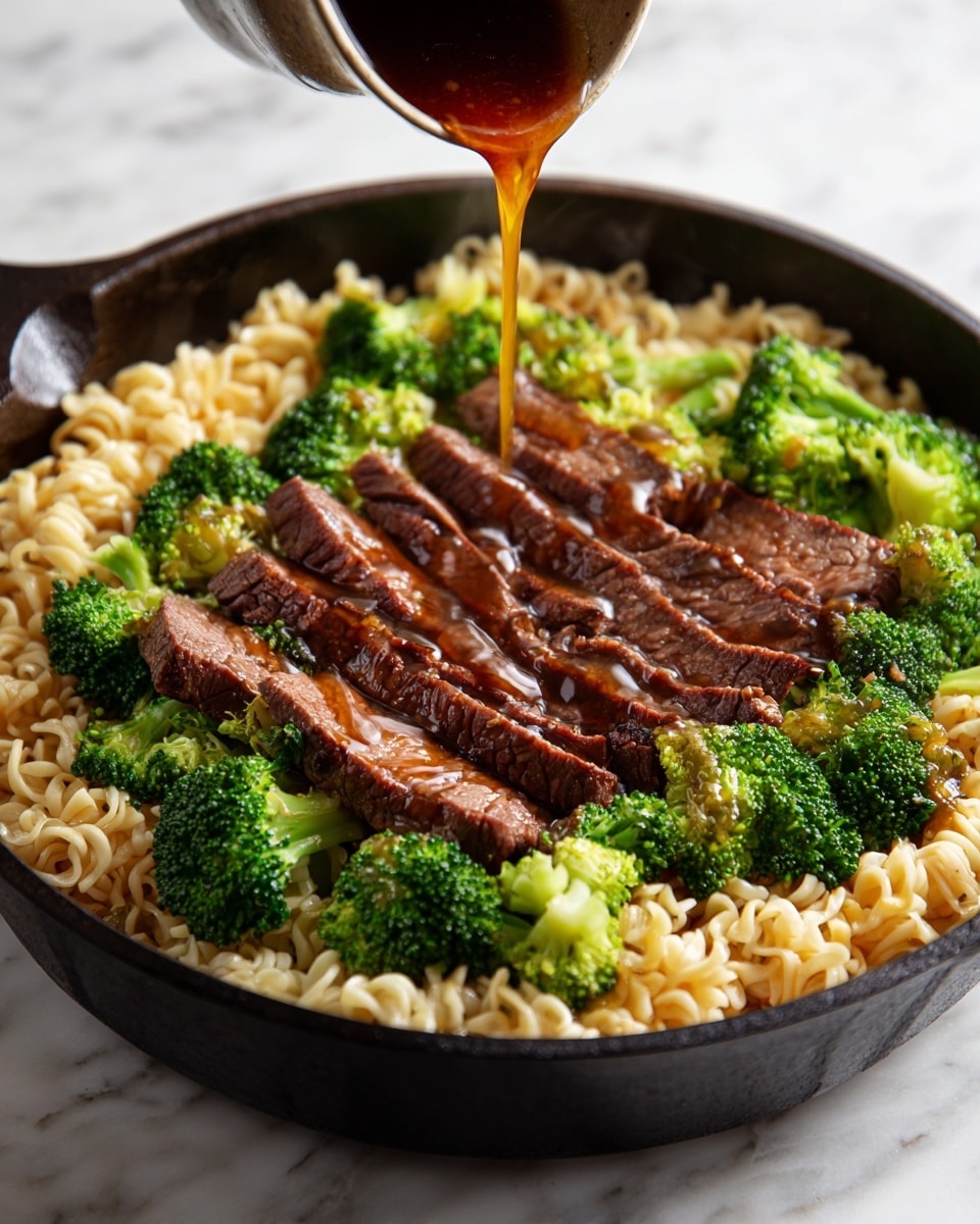 The image shows a close-up of a black cast-iron pan filled with a dish consisting of three main layers: at the bottom, there are light golden-brown cooked noodles with a wavy texture, topped with vibrant green steamed broccoli florets evenly mixed throughout. On top of the broccoli, there are several strips of brown glazed beef placed around the pan, appearing juicy and tender with a shiny surface. A brown sauce is being poured in the center from above, adding a glossy finish to the dish. The pan is set on a white marbled surface. photo taken with an iphone --ar 4:5 --v 7