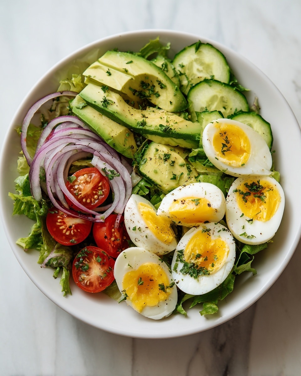 A fresh salad served in a white bowl with a base layer of green leafy lettuce. On top, there are six pieces of hard-boiled egg quarters with bright yellow yolks and white edges, placed in the center. Around the eggs, slices of green avocado are fanned out on one side, and thin translucent red onion rings are scattered nearby. Sliced green cucumber rounds and halved red cherry tomatoes add brightness and color contrast, all sprinkled with chopped herbs and black pepper. The bowl sits on a white marbled surface with soft natural light. Photo taken with an iphone --ar 4:5 --v 7
