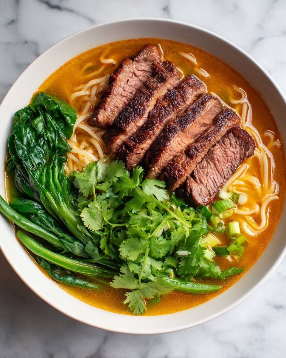 The dish is served in a white round bowl placed on a white marbled surface. The base layer consists of thin noodles immersed in a creamy, orange-brown broth. On top of the noodles, there are several thick slices of grilled steak with a juicy, slightly charred outer texture showing a pink center. Fresh green spinach leaves and vibrant green string beans are arranged neatly on one side of the bowl. Bright green cilantro sprigs garnish the dish, adding a fresh touch. photo taken with an iphone --ar 4:5 --v 7